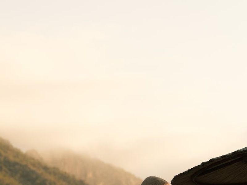 Silhouette of a person meditating at sunset with warm amber tones.